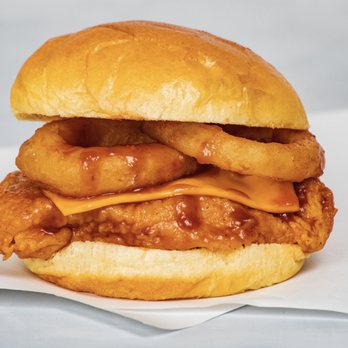 Wings Over Greenville - a fried chicken sandwich with onion rings - Chicken Wings Near Me - Greenville, North Carolina Wings Over Greenville - a fried chicken sandwich with onion rings - Chicken Wings Near Me - Greenville, North Carolina