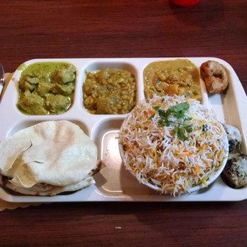 Biryani Pot - 3 Curries on Top, Naan on the bottom left, Biryani on the bottom right, bread and chicken on the far right. - Indian Near Me - Johns Creek, Georgia Biryani Pot - 3 Curries on Top, Naan on the bottom left, Biryani on the bottom right, bread and chicken on the far right. - Indian Near Me - Johns Creek, Georgia