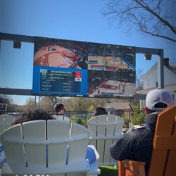 The Mill at Fountain Inn - Outdoor seating with large screen.