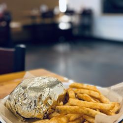 Oklahoma onion burger coming out hot and fresh wrapped in the gold foil