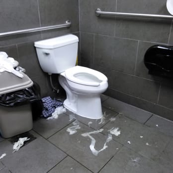 7-Eleven - a toilet and trash can in a public bathroom - Convenience Stores Near Me - Dallas, Texas