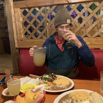 El Paraiso - a man sitting at a table with plates of food and drinks - Mexican Near Me - Asheville, North Carolina El Paraiso - a man sitting at a table with plates of food and drinks - Mexican Near Me - Asheville, North Carolina