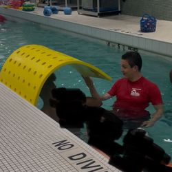 British Swim School of Brooklyn Queens - View of the left side of the pool where a 2nd class (an adult class) is being held.