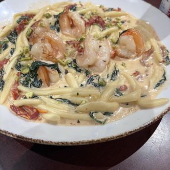 Delicious Heights - Grilled Shrimp with fusilli pasta - A dish of pasta with shrimp, greens, and a creamy sauce, served on a white plate at a casual dining restaurant. - Bars Near Me - Bedminster, New Jersey