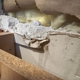 After removing the countertop it became clear pushing it into the wall and down had caused a wedge, pushing out the cabinet below