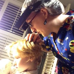 LiceDoctors - Tampa and St. Petersburg - LiceDoctors technician, Trudy, checks for lice and nits (eggs) in her client's hair.