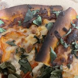 More burnt crust- way too much basil.