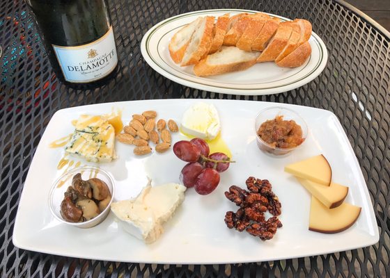 Photo of Arlequin Cafe & Food To Go - San Francisco, CA, US. Artisan Cheese Plate: Four cheeses, fruit, nuts, baguette. (And a bottle of Champagne Delamotte.) #DustinEatsSF