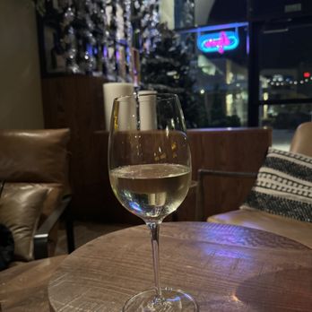 Wine A Little - a glass of wine on a table - Wine Bars Near Me - McKinney, Texas Wine A Little - a glass of wine on a table - Wine Bars Near Me - McKinney, Texas