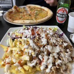 Istanbul Pizza Kebab - Kabab plate with chicken meat, greens, tomatoes, cabbage, purple onions, fries and fresh focaccia bread. DELISH!