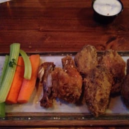 a platter of fried chicken, carrots and celery