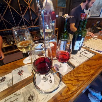 Frontenac Point - a table with wine glasses and menus - Wineries Near Me - Trumansburg, New York