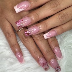 Fong's Nail Studio - Light pink almond nails, some with floral designs and tiny beads for a delicate look.