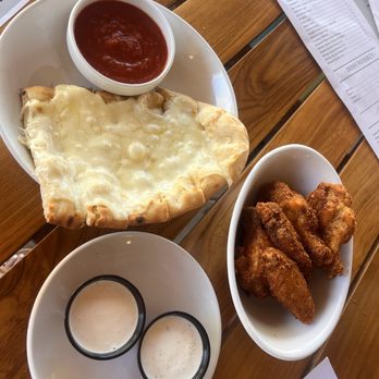 The Vic Bar + Kitchen - Garlic bread & wings with cowboy seasoning - New American Near Me - Buckeye, Arizona