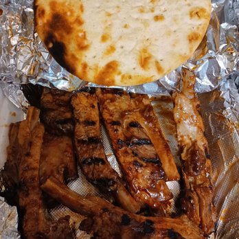 Chicken Lovers - Delicious  ribs, we already ate some!  Must try. Came with pita and BBQ sauce already on the meat. - American Near Me - Bayside, New York
