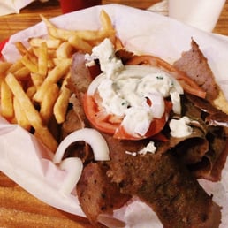 a steak sandwich and french fries a steak sandwich and french fries