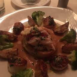 Maine lobster tail with scallops, potatoes and creamy lobster sauce. Maine lobster tail with scallops, potatoes and creamy lobster sauce.