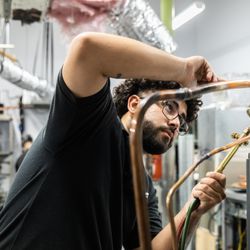 UEI College - Ontario - HVAC student working in lab.