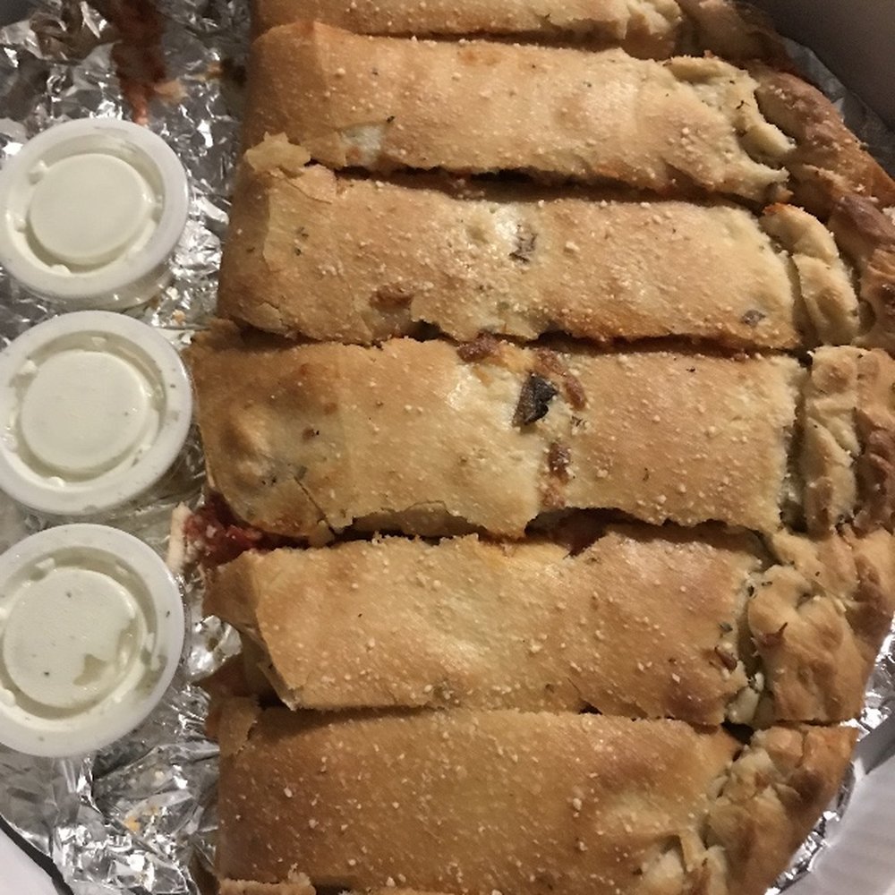 Vesuvio Pizza - a large piece of pizza in a box - Pizza Near Me - Elkhart, Indiana Vesuvio Pizza - a large piece of pizza in a box - Pizza Near Me - Elkhart, Indiana