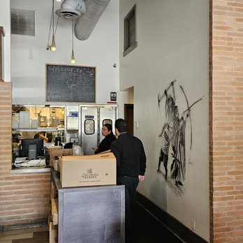 El Rocoto - a man standing at a counter in a restaurant - Peruvian Near Me - Gardena, California El Rocoto - a man standing at a counter in a restaurant - Peruvian Near Me - Gardena, California