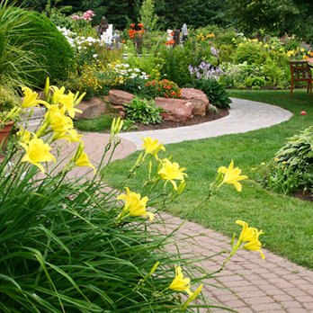 Valdez Landscaping Services - a garden with yellow flowers - Landscaping Near Me