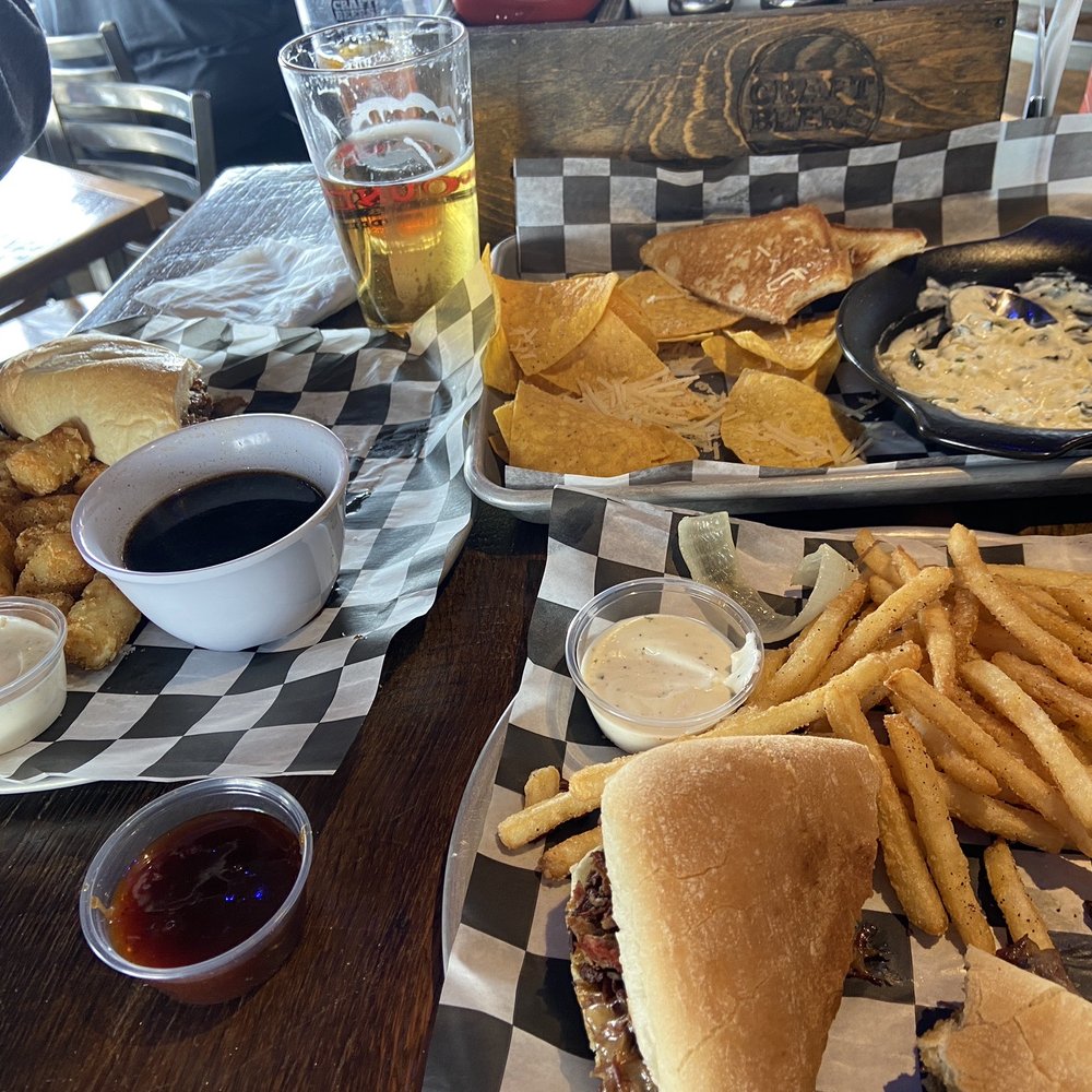 Pounders Pub & Grub - French Dip Sandwich made with ribeye, Brisket Melt Sandwich Spinach and Artichoke Dip! - Sports Bars Near Me - Aberdeen, South Dakota Pounders Pub & Grub - French Dip Sandwich made with ribeye, Brisket Melt Sandwich Spinach and Artichoke Dip! - Sports Bars Near Me - Aberdeen, South Dakota