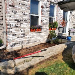 Photo of retaining wall I put in and bare landscape.