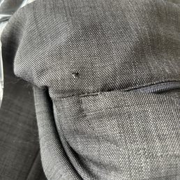 Hole in suit pants below zipper before repairing Hole in suit pants below zipper before repairing