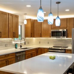 Armstrong Building Services - Natural kitchen- Stained wood cabinets. Quartz Countertop
