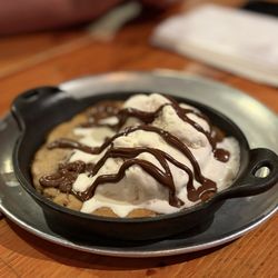 Monster Cookie - Fresh Baked Chocolate Chip Cookie, Vanilla Ice Cream, Nutella Drizzle.  Hot!  Soft chewy cookie..... SO GOOD!!!!!