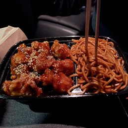 a plate of noodles and meat