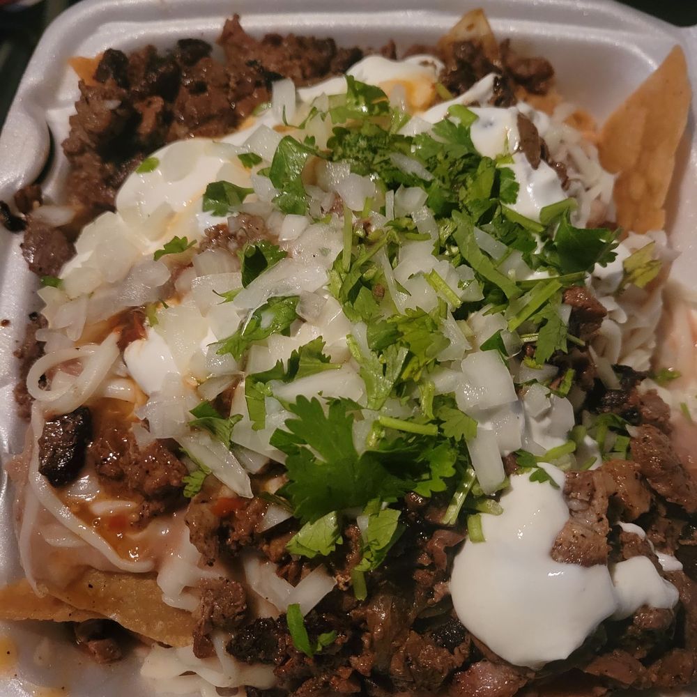 Toros Taqueria - Asada nachos with crema, white onion, Cilantro, and cheese - Tacos Near Me - Norwalk, California