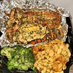 Lobster, Salmon, Shrimp over garlic Parmesan mashed potatoes, with broccoli and Mac and cheese