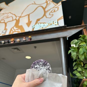 Idlewild Coffee - a hand holding a donut - Coffee & Tea Near Me - Austin, Texas