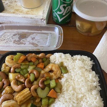 China Express - Euless - Cashew shrimp - A takeout container holds shrimp, mixed vegetables, and white rice, with a Sprite soda can and other food containers on a wooden table. - Chinese Near Me - Euless, Texas
