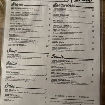 DC Vegan - The menu from DCV vegan restaurant offers a variety of plant-based dishes including sandwiches such as fried artichoke, chick'n cutlet, and classic hoagie, with allergen labels. Bowls include crispy artichoke, meatball, tofu & wild mushroom, and grilled vegetable options. Salads feature Caesar, chick'n Caesar, and vegan options. Sides include side salad, warm focaccia, and fries. Soups include wedding soup. Prices range from $7 to $18, with some dishes marked gluten-free or soy-free. - Vegan Near Me - Washington, DC, District of Columbia