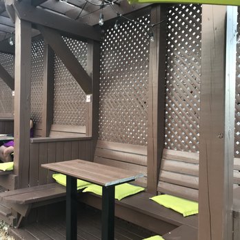 Lagabiere - a wooden bench with yellow cushions - Brasseries Near Me - Saint-Jean-sur-Richelieu, Quebec