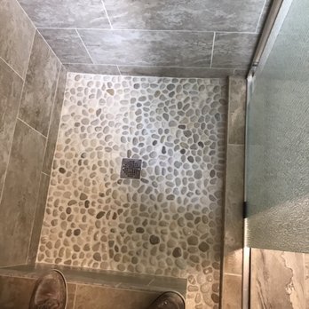 Messner's Remodeling - a person standing in a shower - Flooring Near Me Messner's Remodeling - a person standing in a shower - Flooring Near Me