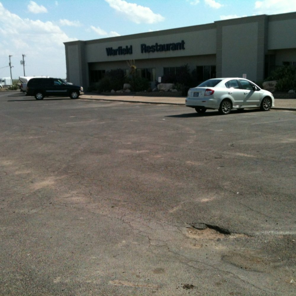 Warfield Restaurant - a parking lot with cars parked in front - New American Near Me - Midland, Texas