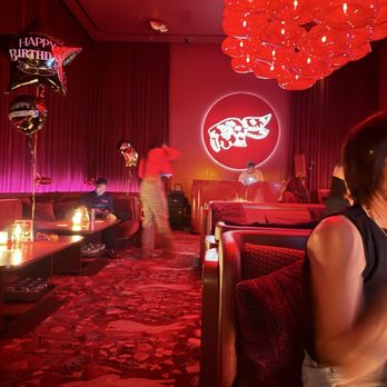 Wax Rabbit Speakeasy - Showing a staff member lounging in a booth on his phone - Speakeasies Near Me - Las Vegas, Nevada Wax Rabbit Speakeasy - Showing a staff member lounging in a booth on his phone - Speakeasies Near Me - Las Vegas, Nevada