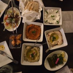 Medii Kitchen - Tapas medley-stuffed grape leaves, hummus, falafel, baba ganoush, muhumara, cheese boreg, pita, and tzatziki.