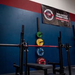 Competition powerlifting combo rack with Kabuki power bar and rogue calibrated plates