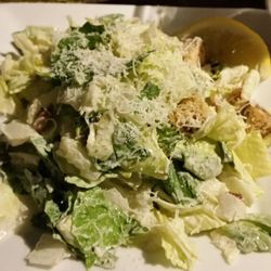 Caesar Salad with croutons and bacon bits.
