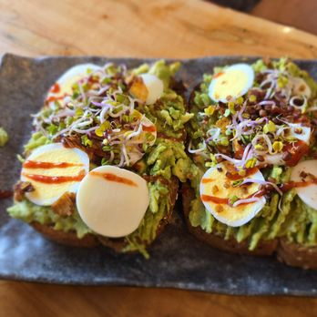 Cafe Surfinista - Avocado toast with toasted coconut flakes, radish sprouts and bacon - Juice Bars & Smoothies Near Me - Indialantic, Florida Cafe Surfinista - Avocado toast with toasted coconut flakes, radish sprouts and bacon - Juice Bars & Smoothies Near Me - Indialantic, Florida