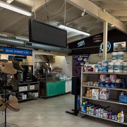 Trail Market Tacos - A small cafe in on corner of the market. Two tables are behind the shelving.