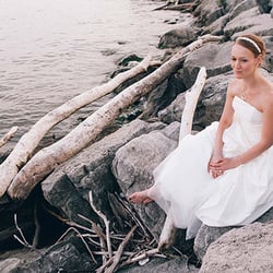 Don Toye Photography - Bride sitting by shore of Lake Ontario in Toronto.