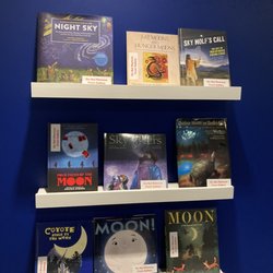 Art Gallery of Alberta - Books that relate to the moon cycles within the nearby artwork area showcasing Lana Whiskeyjack