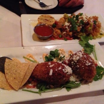 The Union Kitchen - Pepper calamari with pepproncini peppers, feta, green onions & scampi butter!  Crab stuffed avocado! - New American Near Me - Houston, Texas