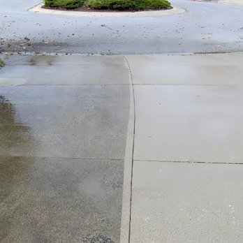 We Clean Driveways - Side by side of dirty and clean driveway - Pressure Washers Near Me