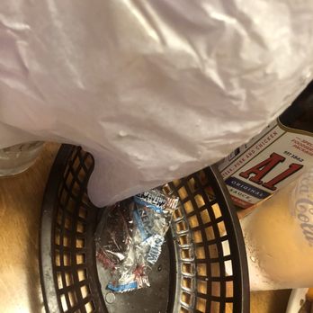 Texas Roadhouse - This used wrapper was under our bread basket. The Service Manager Samantha did apologize but that was it! - Steakhouses Near Me - Winchester, Virginia